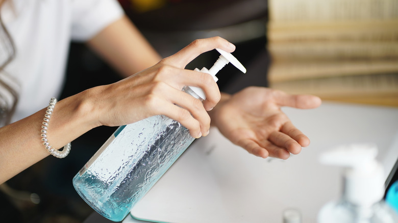 Woman washing her hands with antibacterial soap