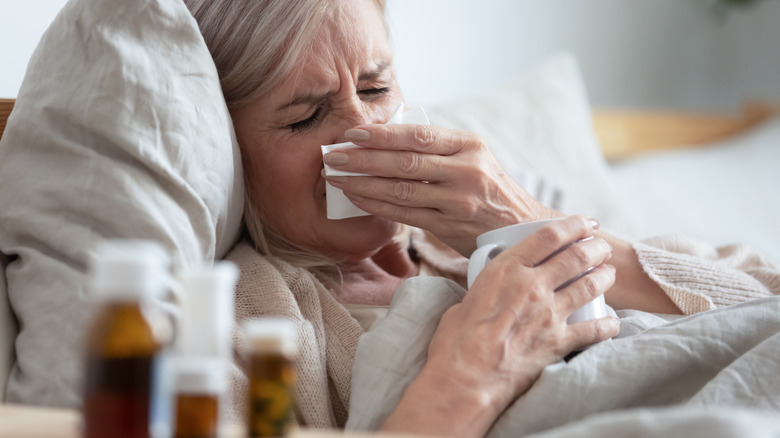 woman blowing her nose