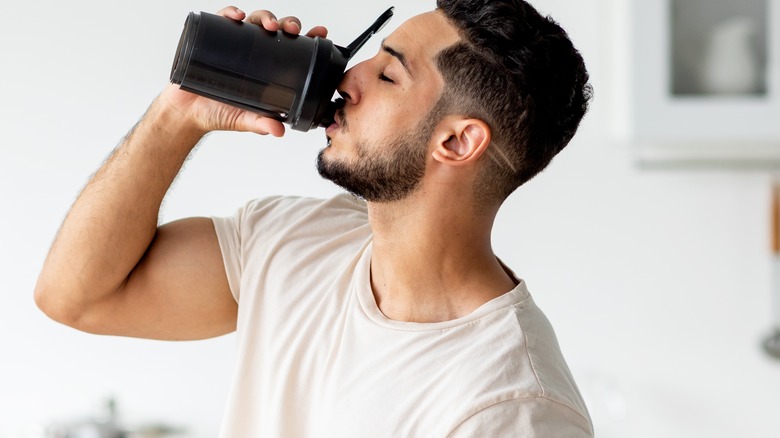 Man drinking from black cup