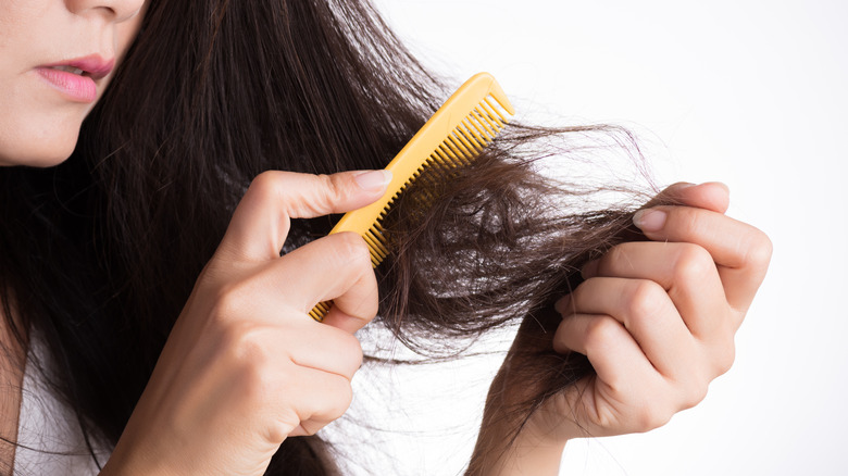 Woman with damaged hair from product buildup