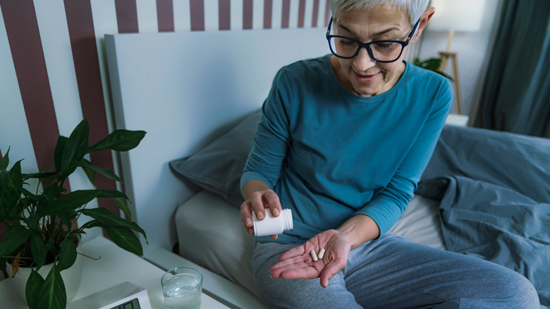 older woman taking sleeping pills