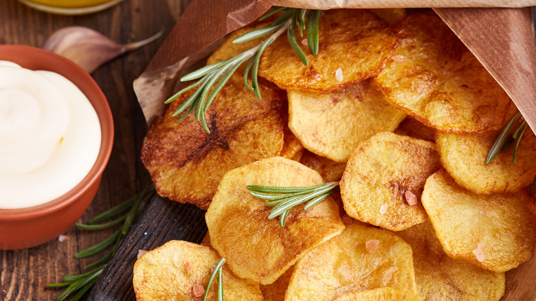 homemade crispy potato chips with rosemary and a side of aioli 
