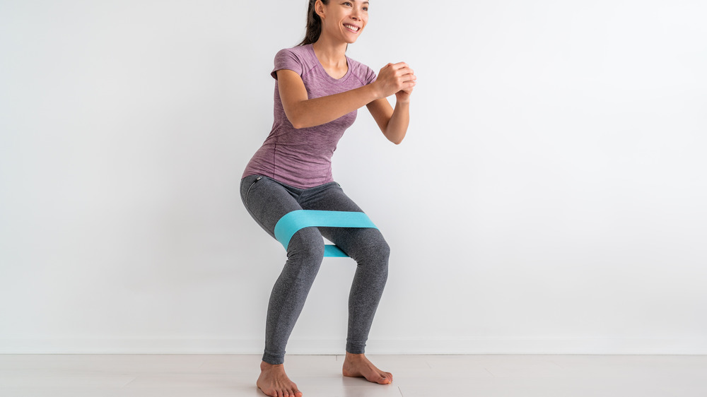 Woman doing banded squats