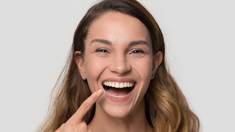 Woman pointing to her teeth