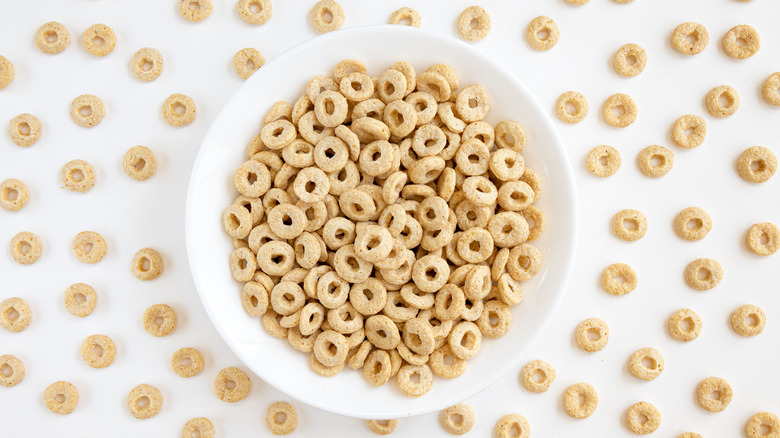 A bowl of Cheerios with a white background