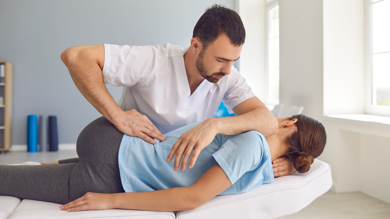 chiropractor working on female patient