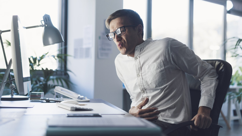 a man constipated at work 