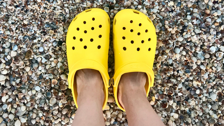 yellow crocs on pebbles