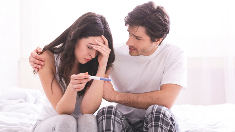 couple looking at pregnancy test