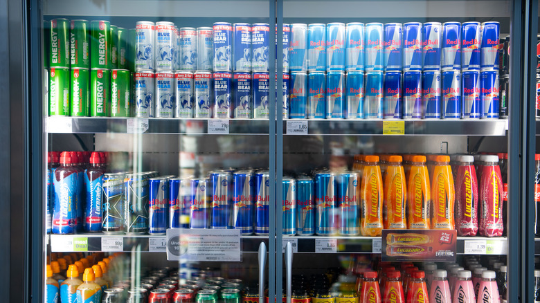 View of a closed cooler in a store holding energy drinks