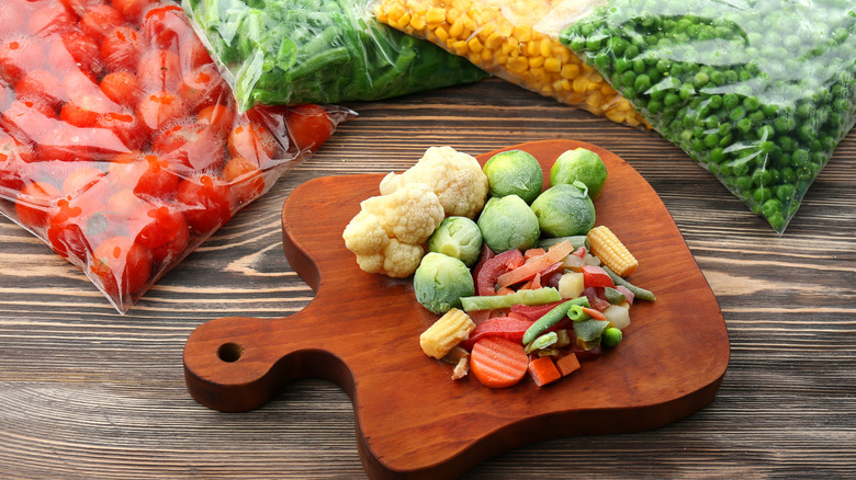 frozen vegetables in bags and on chopping board
