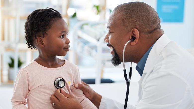 Doctor smiling at young child