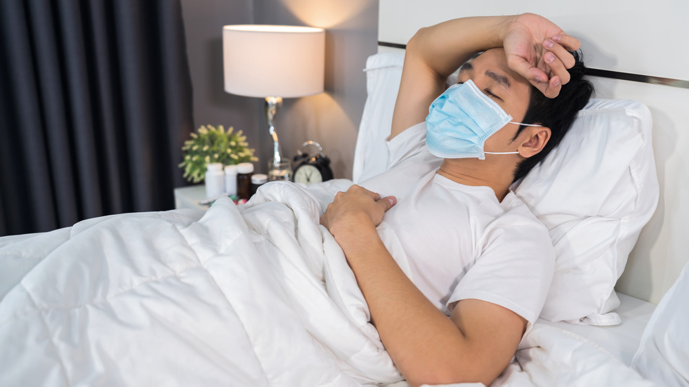 Man with headache in mask