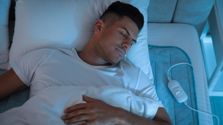 Man sleeping with heating pad