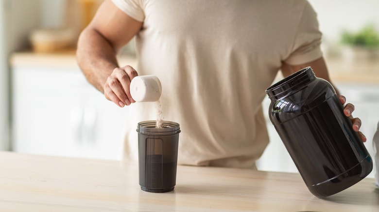 man making protein drink