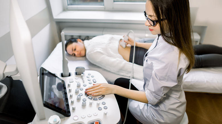 Clinician performs ultrasound on patient
