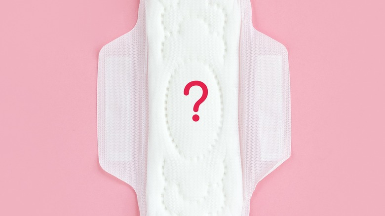 Сlean feminine sanitary napkin with question mark.