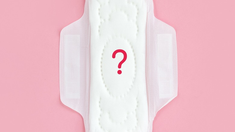 Сlean feminine sanitary napkin with question mark.