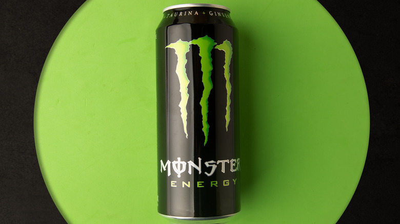 Monster Energy drink on green background