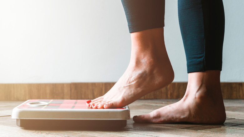 Person stepping on scale