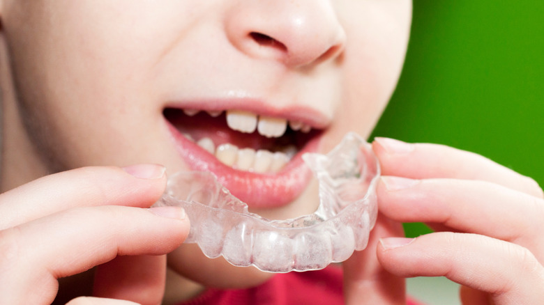 boy holding a mouth guard