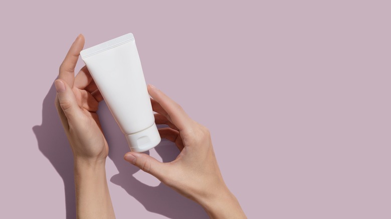 woman holding lotion product