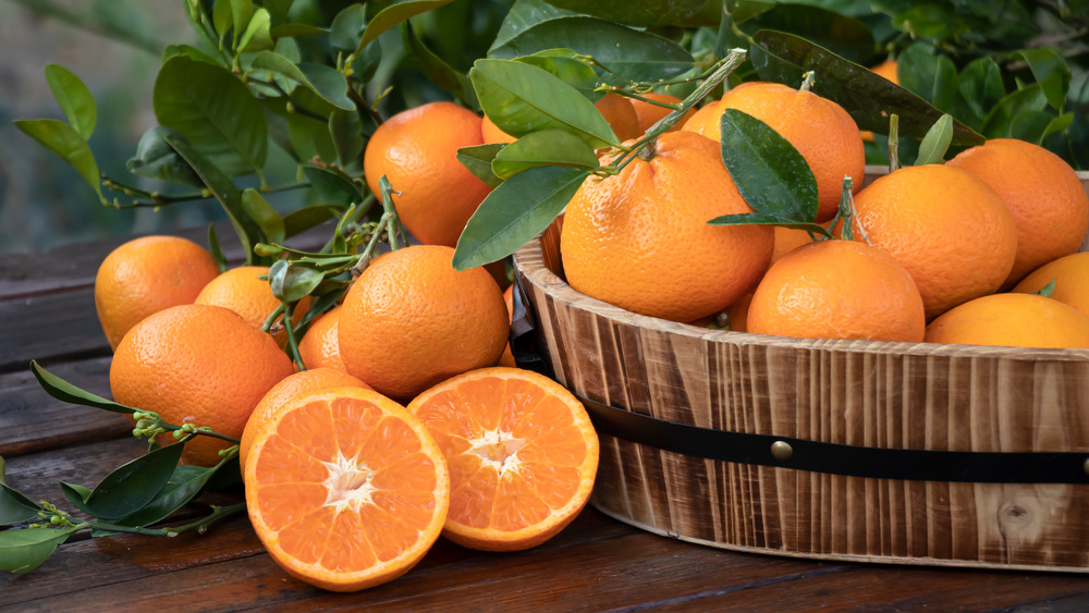 Basket of oranges with peel and leaves