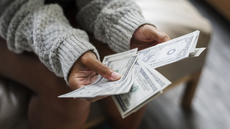 woman holding cash