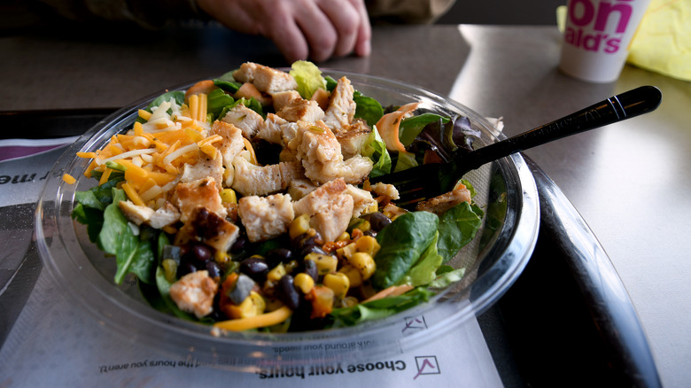 A McDonald's salad sits on a table