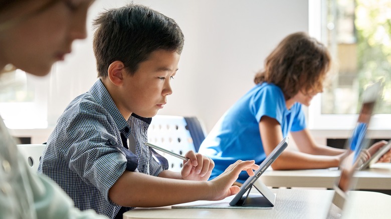 A student looks at a computer in school