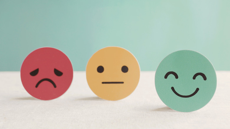 A sad, neutral, and happy face