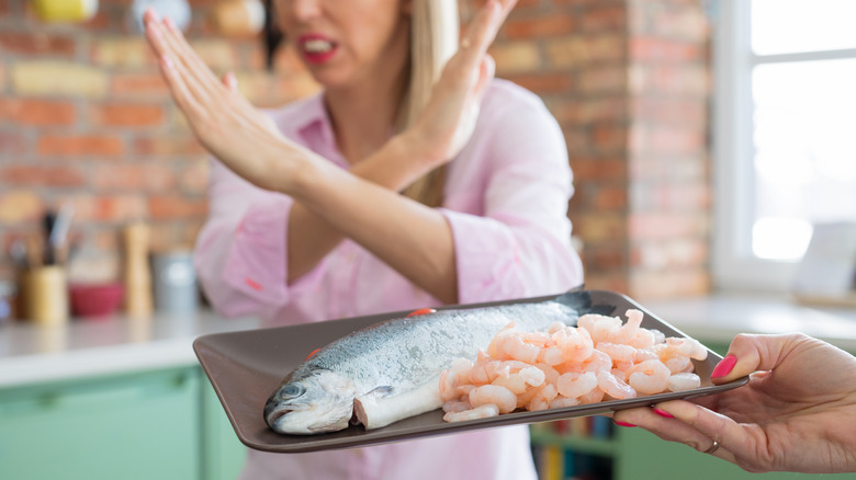 woman refusing fish and shrimp