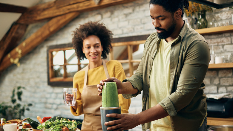 Couple blending a smoothie