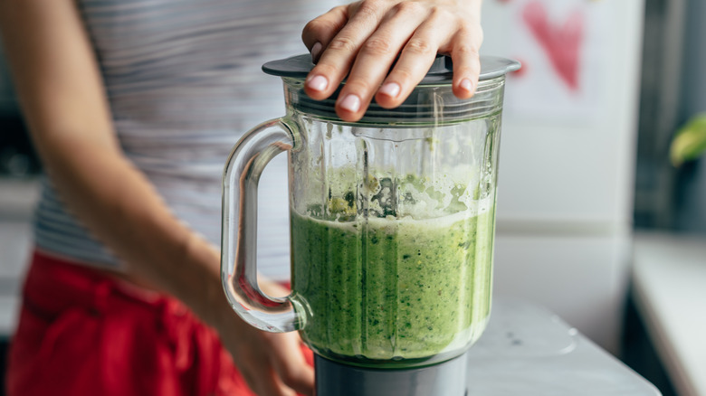 Woman blending a smoothie