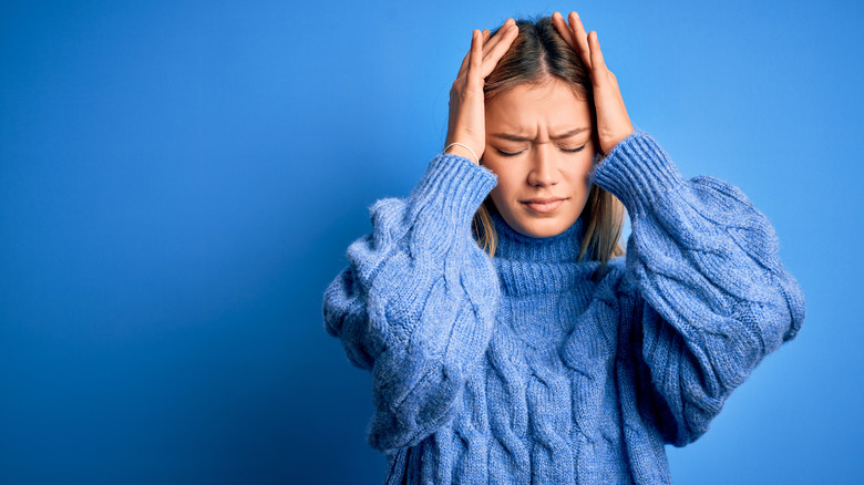 stressed woman holding head