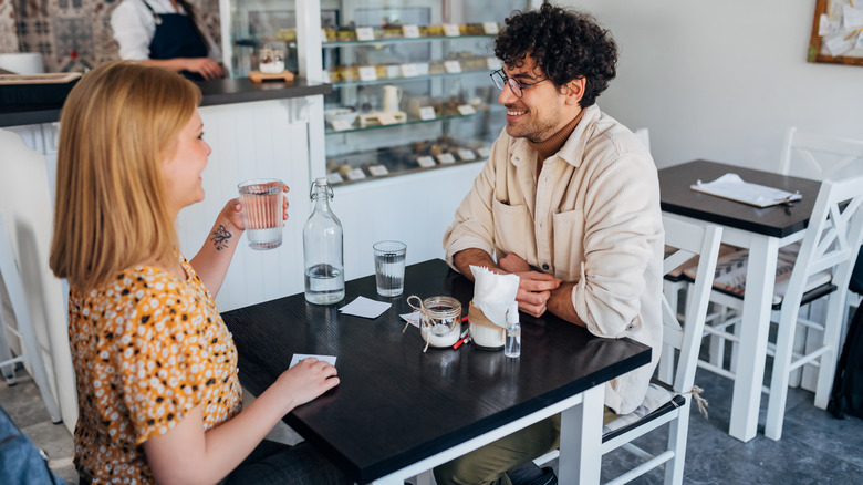 couple drinking water at cafe