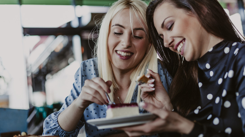 women eating cheesecake happy