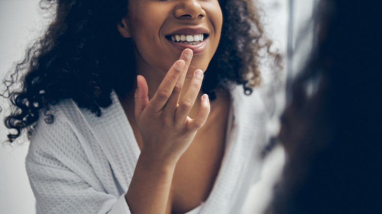woman looking at her teeth
