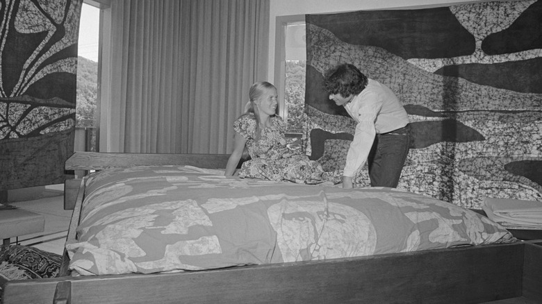 A woman listening to a salesman at Come Together Waterbeds talk about the virtues of waterbeds.