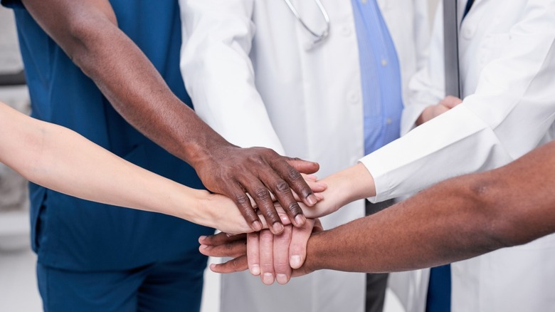 Hands of multi-ethnic medical team