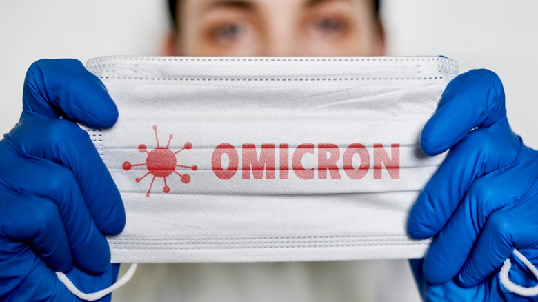 Nurse holding mask that says 'Omicron'