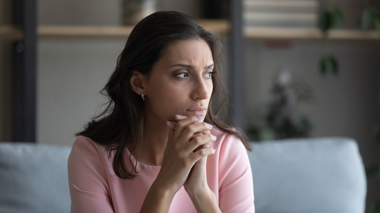 Woman sitting with worried look