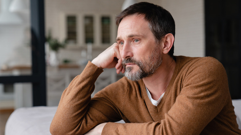 Worried looking man on couch