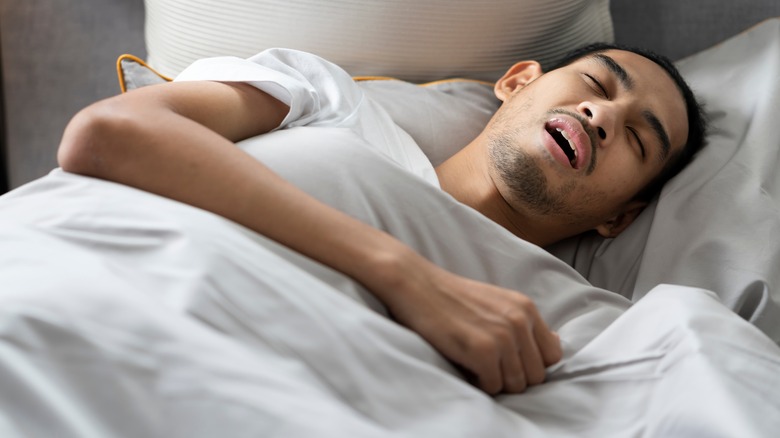 Young man asleep with open mouth