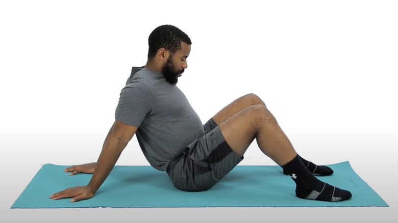 man doing seated bicep stretch