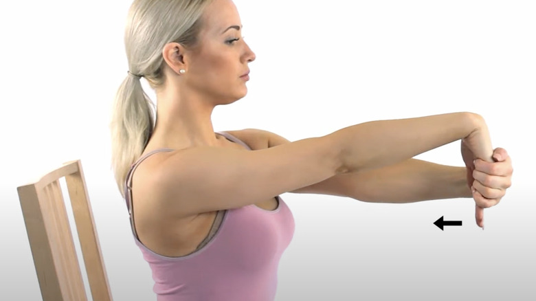 woman performing wrist flexion stretch