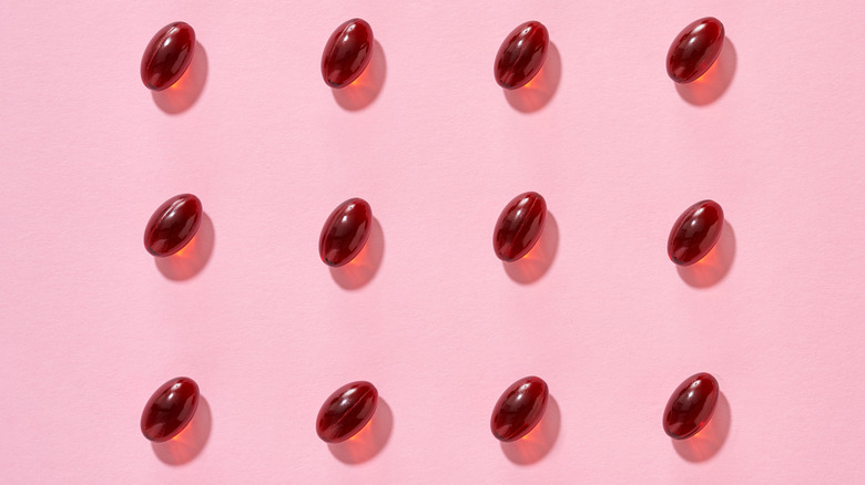 Red capsules on pink background