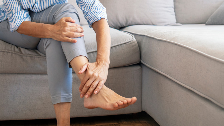 woman touching feet