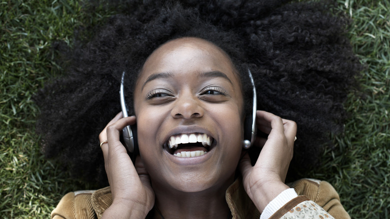 Smiling young woman wearing headphones