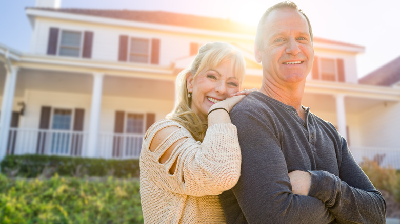 woman smiling in front of house